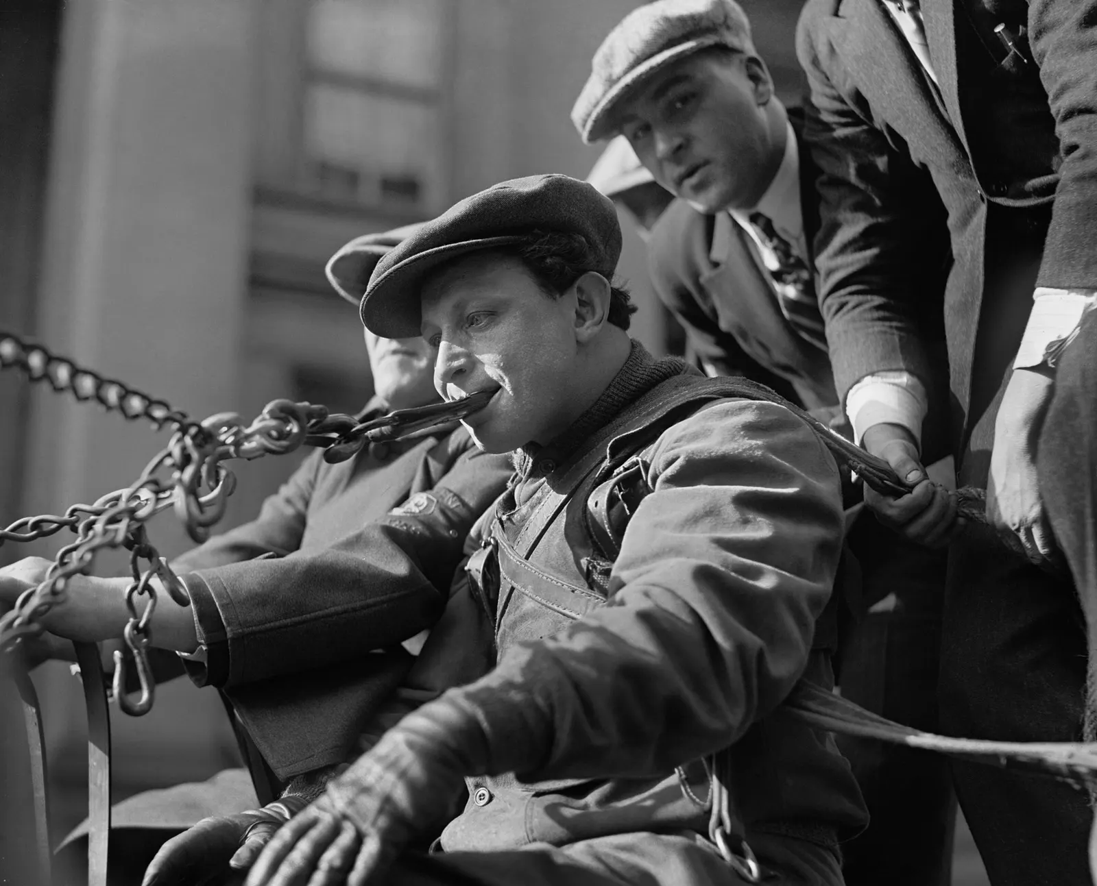 Siegmund “Zishe” Breitbart pulling a heavy weight using his teeth, November 1923; original glass negative by the National Photo Company; restored by Michel Vuijlsteke. Library of Congress Prints and Photographs Division, digital ID npcc.09986; public domain in the United States. Source: https://commons.wikimedia.org/wiki/File:Siegmund_Breitbart2.jpg.