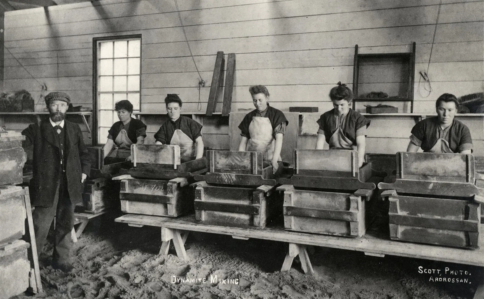 documentary photograph described as women mixing nitroglycerin with sorbents and stabilizers at Nobel’s Ardeer Factory in 1897. Photographer and original source are not identified on the Commons page. Marked public domain in Sweden and the United States; Commons notes that status may differ elsewhere. Credit unknown photographer, via Wikimedia Commons. Source: [Wikimedia Commons file page](https://commons.wikimedia.org/wiki/File:Women_mixing_dynamite_at_Nobel%E2%80%99s_Ardeer_Factory_in_1897.jpg). Original image, no edits; checked 18 October 2026.