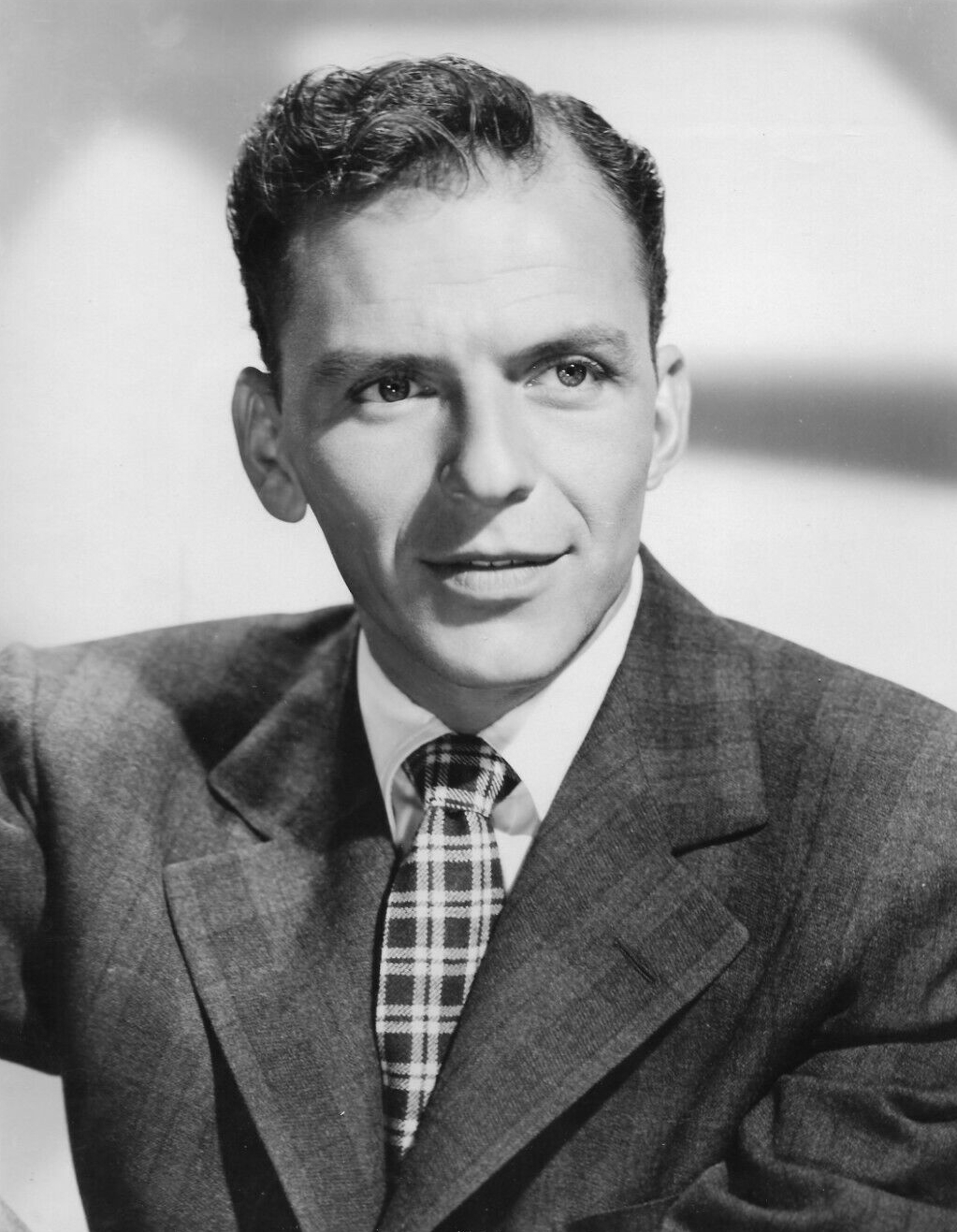MGM publicity portrait of Sinatra, photographed by George Hurrell in 1942. The scanned 1959 print has no renewed copyright record, so it is marked public domain in the United States; Commons file page: https://commons.wikimedia.org/wiki/File:Frank_Sinatra_(1942_photo_portrait).jpg. Attribution not required; kept here for provenance. No edits.
