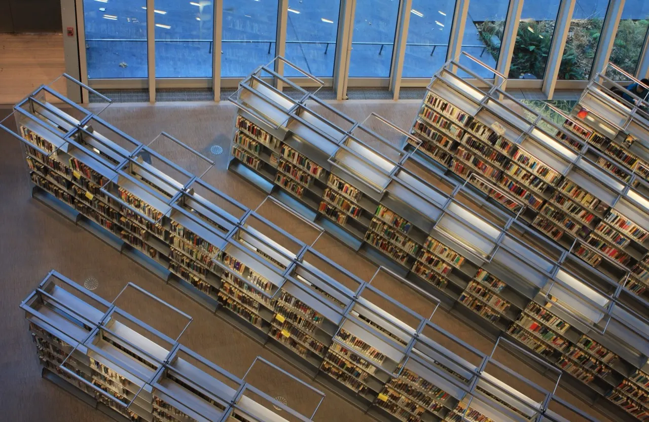 bookshelves inside Seattle Central Library, photographed 6 December 2009; contextual image for the annual reference-book format, not Guinness material. brewbooks, Wikimedia Commons, https://commons.wikimedia.org/wiki/File:Bookshelves_-_Seattle_Central_Library_-_Flickr_-_brewbooks.jpg, CC BY-SA 2.0 (https://creativecommons.org/licenses/by-sa/2.0/). Attribution: brewbooks, “Bookshelves - Seattle Central Library,” CC BY-SA 2.0, via Wikimedia Commons. Resized to 1280 px wide; checked 2026-10-18.