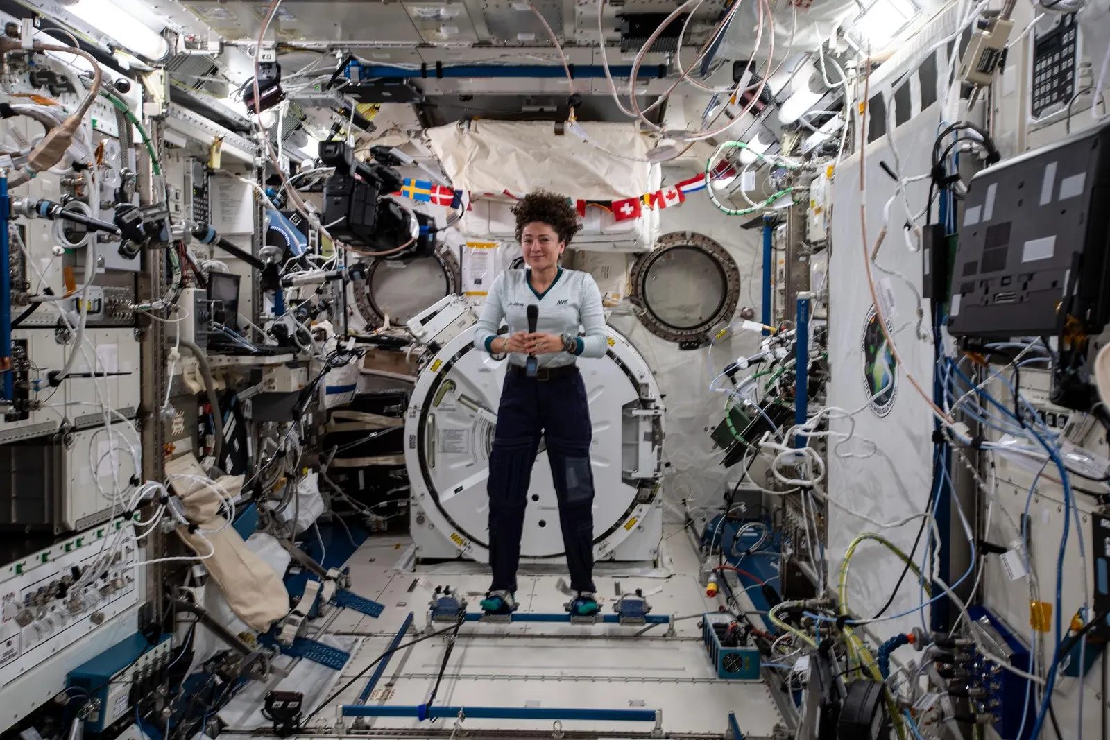 NASA image ISS061E026260, Jessica Meir attached to foot restraints in the Kibo laboratory module on 1 November 2019. NASA credit; U.S. federal public-domain work. Source: https://images-assets.nasa.gov/image/iss061e026260/iss061e026260~large.jpg. Documentary context image illustrating foot restraints, not a depiction of skin changes.