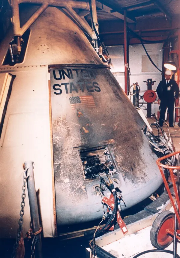 Apollo 1 command module photographed after the fire, 28 January 1967. NASA-created image; public domain in the United States. Photographer credit: Kipp Teague. Wikimedia file page: https://commons.wikimedia.org/wiki/File:Apollo_1_%E2%80%93_Exterior_view_of_spacecraft_after_fire.jpg. Downloaded original; no edits.