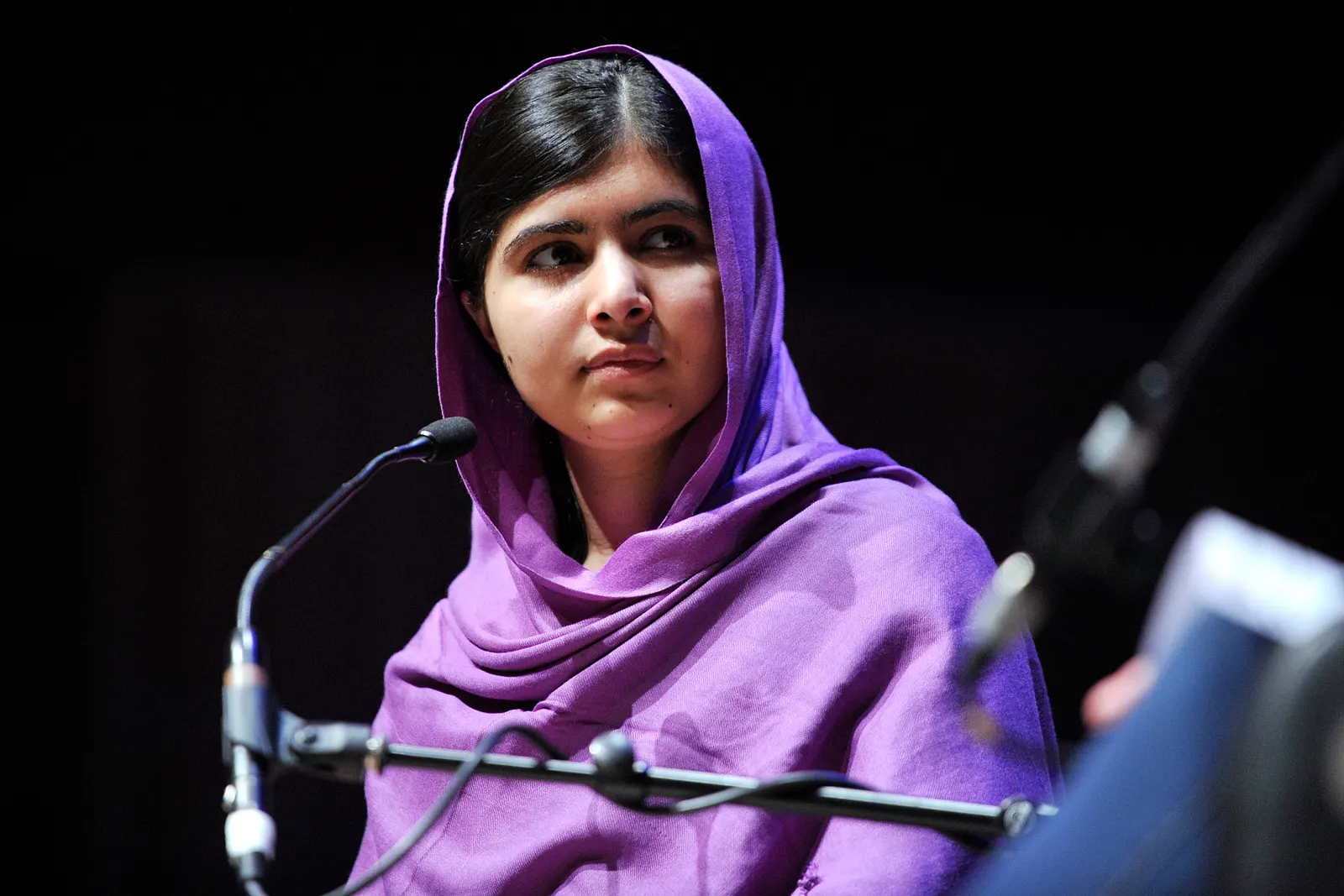 documentary photo of Malala Yousafzai speaking at WOW 2014, Southbank Centre, on 8 March 2014. Original asset page: [Wikimedia Commons](https://commons.wikimedia.org/wiki/File:Malala_Yousafzai.jpg); original source: [Southbank Centre Flickr](https://www.flickr.com/photos/southbankcentre/13008430294/). Creator: Southbank Centre. License: [CC BY 2.0](https://creativecommons.org/licenses/by/2.0/), verified on the file page; attribution required: “Southbank Centre, CC BY 2.0, via Wikimedia Commons.” Personality-rights warning appears on Commons; this is an editorial documentary portrait. No crop or content edits. Downloaded and visually checked 18 October 2026; 3000×2000 px.