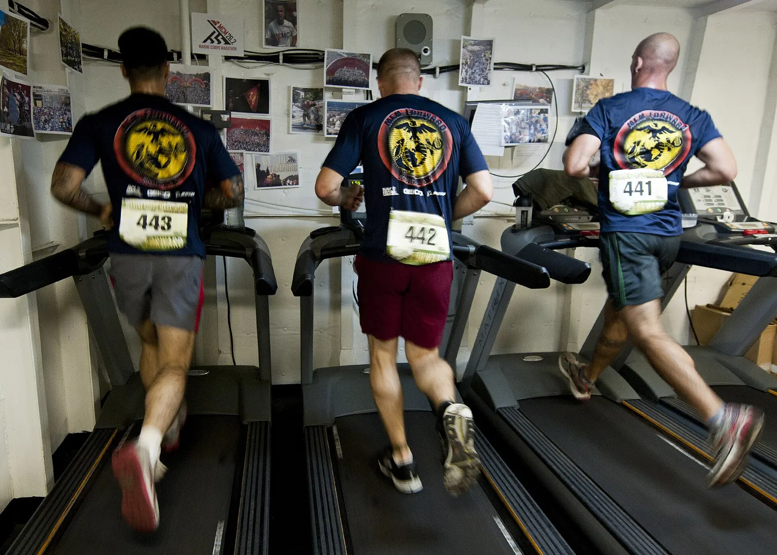 U.S. Marines running on treadmills for a marathon, U.S. Fifth Fleet area, 27 October 2012; photographer Mass Communication Specialist 3rd Class Jonathan Sunderman, U.S. Navy; U.S. federal government public domain. Original page: https://commons.wikimedia.org/wiki/File:Flickr_-_Official_U.S._Navy_Imagery_-_Marines_run_on_treadmills_for_a_marathon..jpg. Credit: U.S. Navy photo by MC3 Jonathan Sunderman.