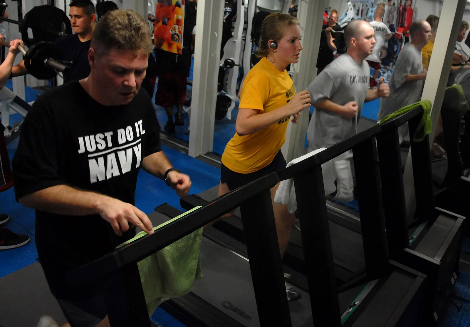 U.S. Navy sailors running on newly installed treadmills aboard USS Ronald Reagan, 5 February 2007; photographer Mass Communication Specialist 2nd Class Joseph M. Buliavac, U.S. Navy; U.S. federal government public domain. Original page: https://commons.wikimedia.org/wiki/File:US_Navy_070205-N-3659B-036_Sailors_on_board_USS_Ronald_Reagan_(CVN_76)_run_on_newly_installed_treadmills_in_the_mezzanine_gym.jpg. Credit: U.S. Navy photo by MC2 Joseph M. Buliavac.