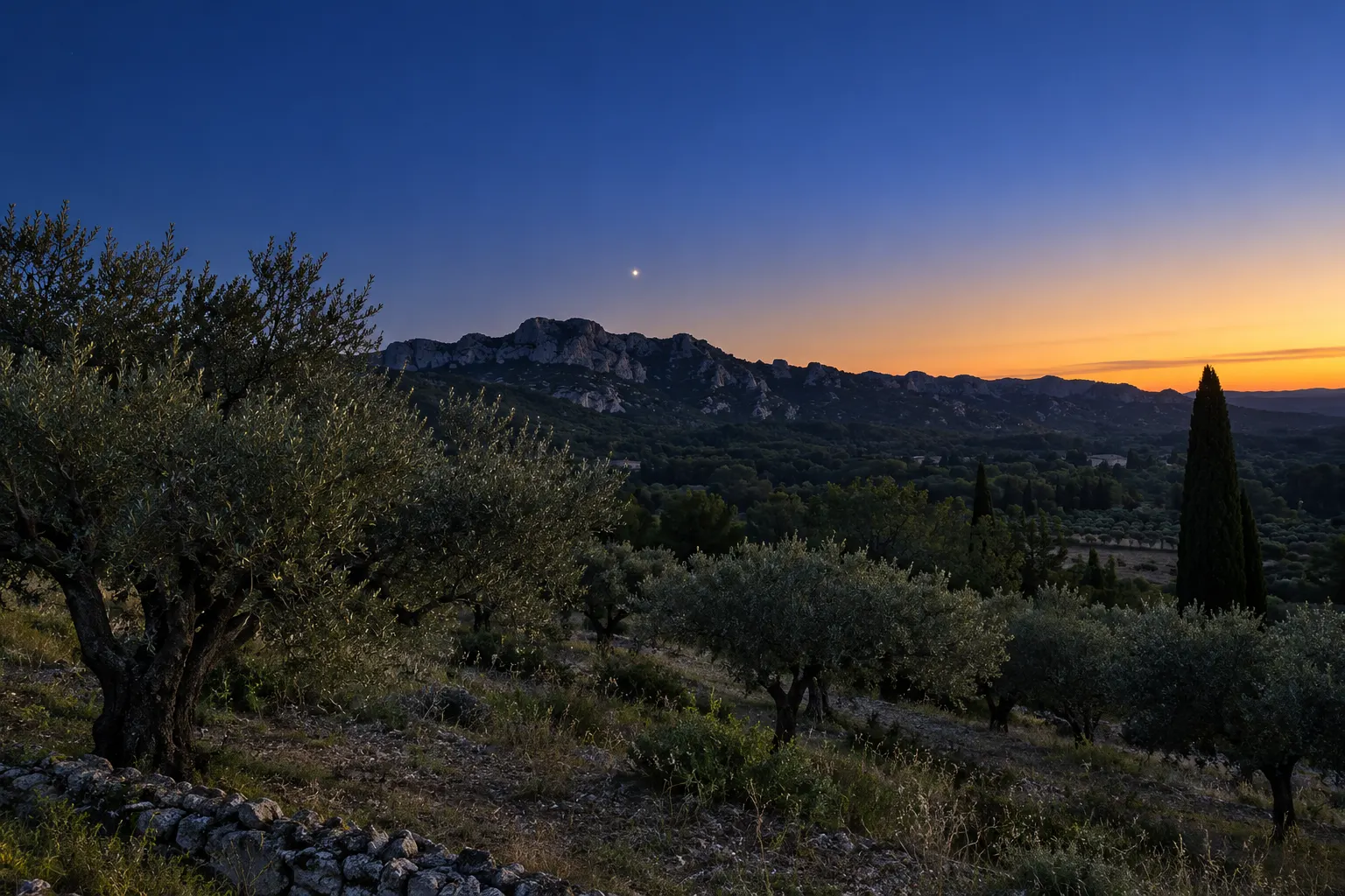 AI-generated predawn landscape of the Alpilles with a bright planet above the ridge.