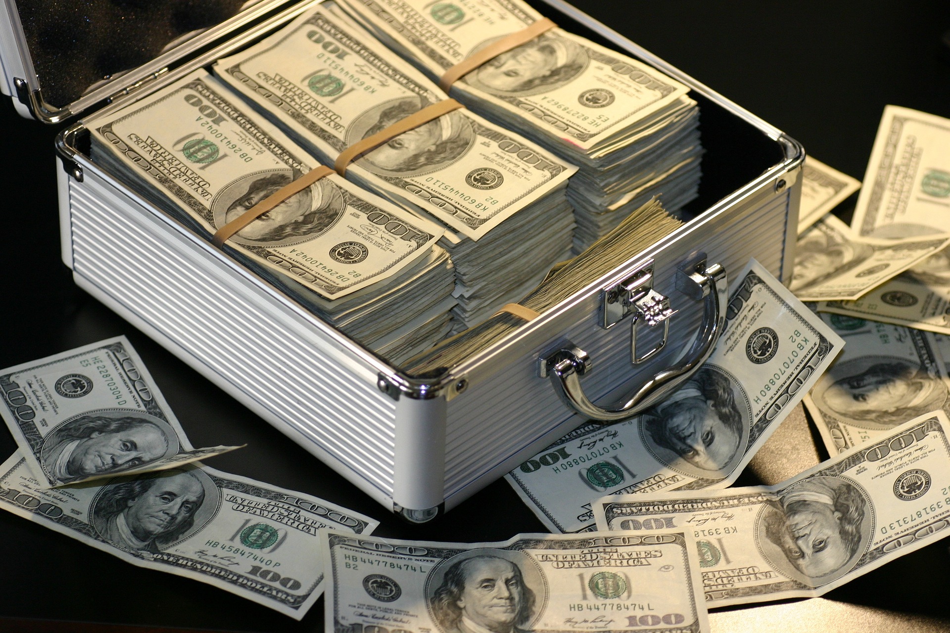 $100 bills in a metal case, not verified as movie props; creator/image released under CC0 via Pixabay; original https://commons.wikimedia.org/wiki/File:Money-1428594_1920.jpg