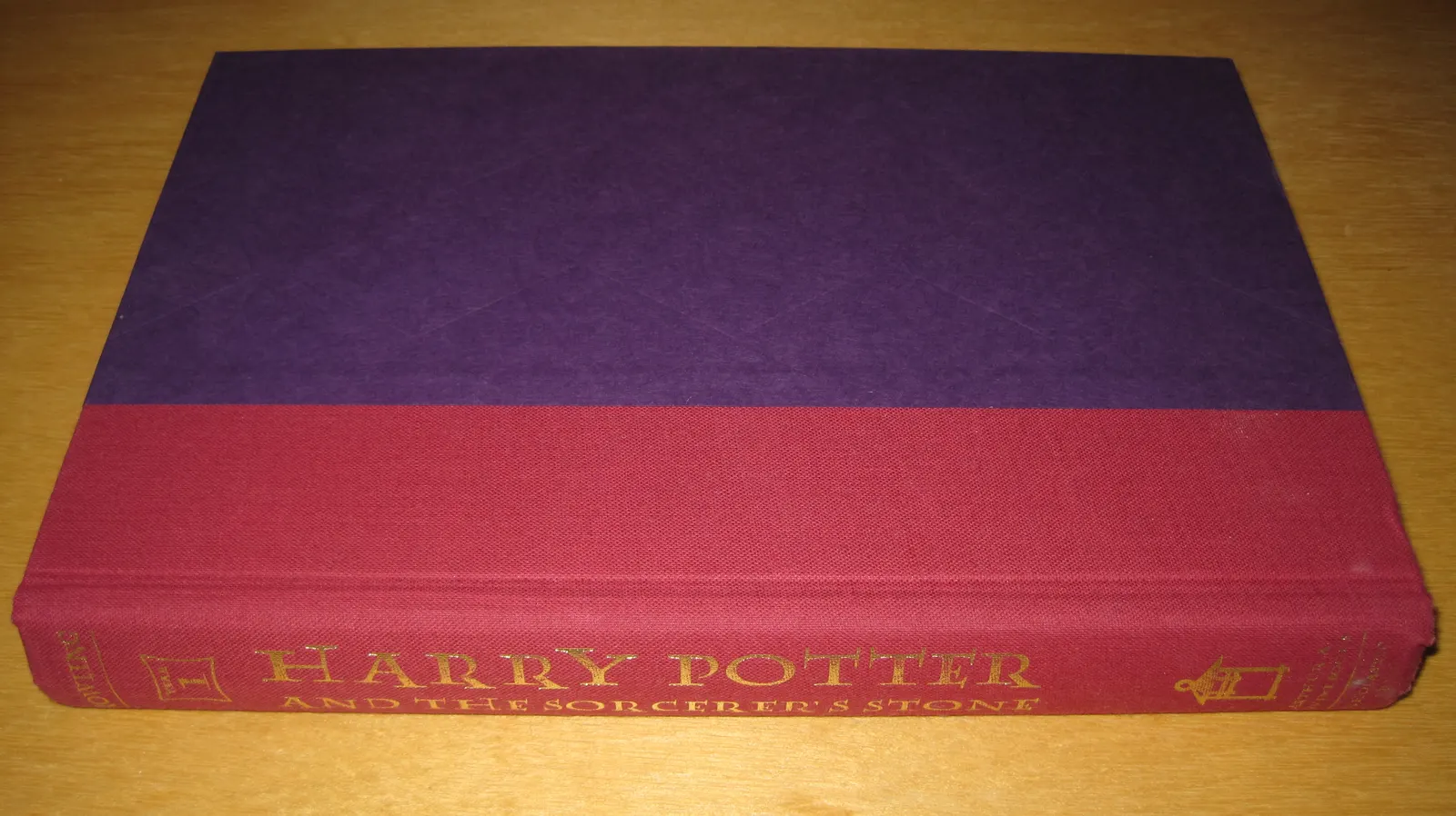 a first American edition of *Harry Potter and the Sorcerer’s Stone* without its dust jacket. Photographer: BrokenSphere; original: https://commons.wikimedia.org/wiki/File:Harry_Potter_Book_1,_1st_American_ed._without_dust_jacket.JPG. CC BY-SA 3.0 (or GFDL); attribution: “BrokenSphere, CC BY-SA 3.0, via Wikimedia Commons.” No edits. It is a US edition photographed in 2010, not the UK first-impression copy that sold at the 2024 auction.