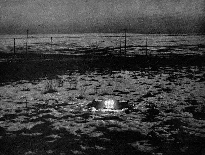 Historical photograph of three lamps lit by an electrical oscillator in Tesla's Colorado Springs experiment, published with his 1900 article. This documents real electrical research and is distinct from the fictional human-duplication device in the film. Original asset page: https://commons.wikimedia.org/wiki/File:Experiment_in_wireless_power_transmission_by_Nikola_Tesla_at_his_laboratory_in_Colorado_Springs_in_1899.png. Creator: Nikola Tesla (experiment and original publication); uploader/source attribution on Commons is Szymonel's improved scan. License: Public Domain Mark 1.0; no attribution required, credit retained for provenance. Terms: https://creativecommons.org/publicdomain/mark/1.0/. Checked: 2026-10-19. Edits: none; original 832×630 PNG.