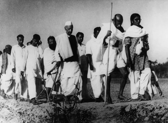 documentary photograph of Gandhi in Noakhali, 1946. Photographer not identified on file page. The Commons file page marks the photograph public domain in India and Bangladesh as a pre-1966 photograph; it notes that status can differ in some countries. Attribution: unknown photographer, via Wikimedia Commons. Source: [File page](https://commons.wikimedia.org/wiki/File:Gandhi_in_Noakhali_1946.jpg). Original file, no edits; checked 18 October 2026.