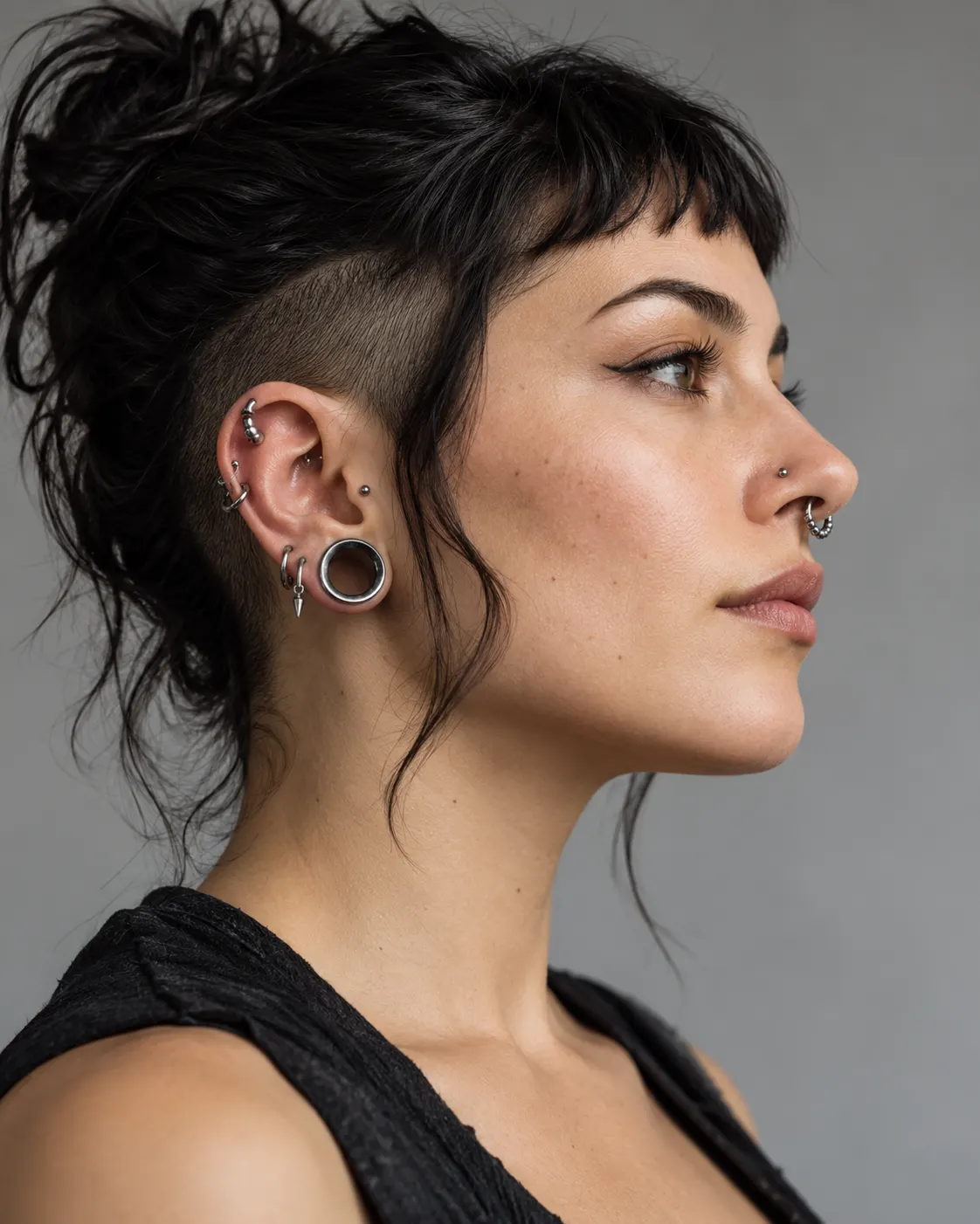 AI-generated cover: fictional adult in side profile with tasteful facial and ear piercings; not Rolf Buchholz. Prompt: “Photorealistic vertical 4:5 editorial cover about body modification as personal expression. A generic adult person shown in respectful side profile in a clean studio, wearing several tasteful facial and ear piercings, natural skin, nonsexual and non-graphic. The subject is fictional and not Rolf Buchholz. No tattoos with text, no logos, no split tongue, no surgical procedure.” Generated 20 October 2026.