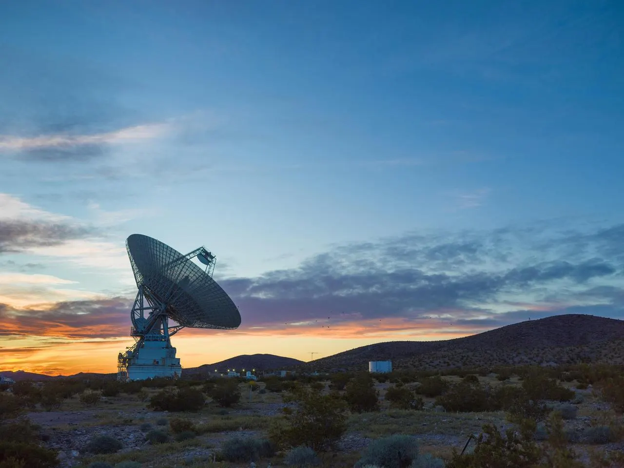 photograph of Goldstone DSS-14 70-meter radar antenna at sunset. Original page: https://science.nasa.gov/photojournal/the-goldstone-solar-system-radar-at-sunset/ . Photographer/credit listed by NASA Photojournal; public NASA imagery, with credit NASA/JPL-Caltech unless page-specific credit directs otherwise. Downloaded NASA 1280px rendition; no edits.