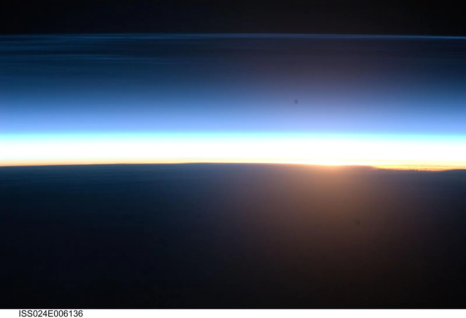 NASA image ISS024E006136, polar mesospheric clouds illuminated by an orbital sunrise, photographed by an Expedition 24 crew member on 16 June 2010. NASA credit; U.S. federal public-domain work. Source: https://images-assets.nasa.gov/image/iss024e006136/iss024e006136~large.jpg. Documentary example of orbital sunrise.