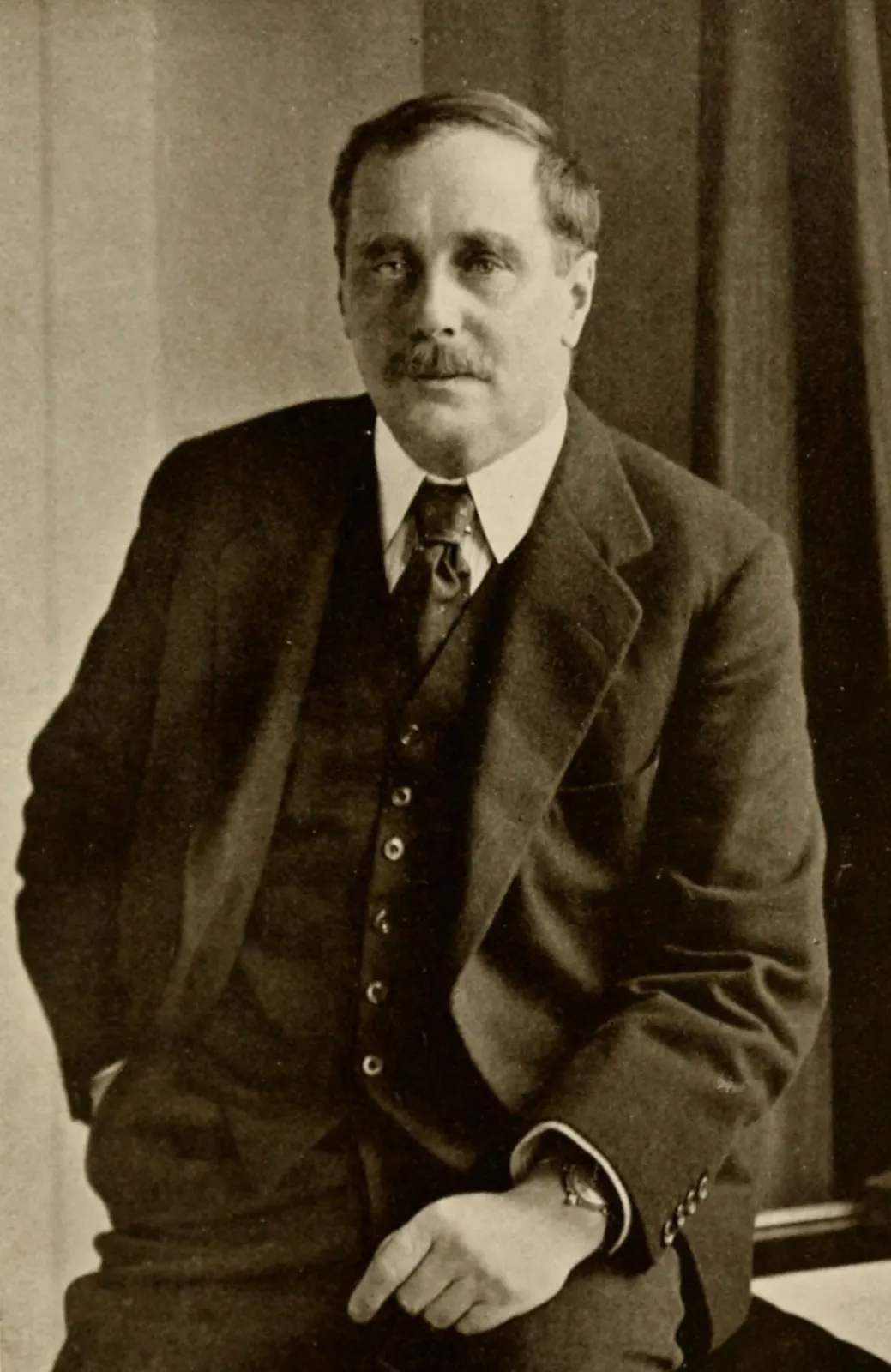 period portrait of H. G. Wells from an anonymous photograph published in *The Story of the House of Cassell* (1922). The image page identifies the original book and marks the scan public domain in the United States; the unknown photographer and publication date support public-domain status in Ukraine under the 70-year term for anonymously published works in Law No. 2811-IX, Article 31. Source page: https://commons.wikimedia.org/wiki/File:Portrait_of_H._G._Wells.jpg. Credit the source book / Cassell & Company; no crop or retouch.