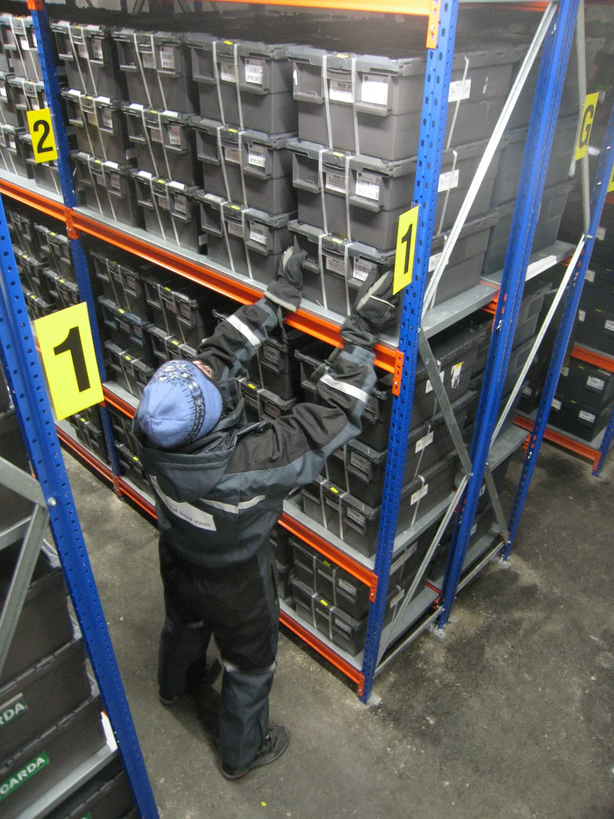 NordGen / Dag Terje Filip Endresen, storage containers inside the Seed Vault on 27 February 2008. Wikimedia Commons; public domain dedication; photographer requests acknowledgement. This is the 1,920-pixel Wikimedia thumbnail rendition; no additional edits. https://commons.wikimedia.org/wiki/File:Storage_containers_in_Svalbard_Global_Seed_Vault_01.jpg