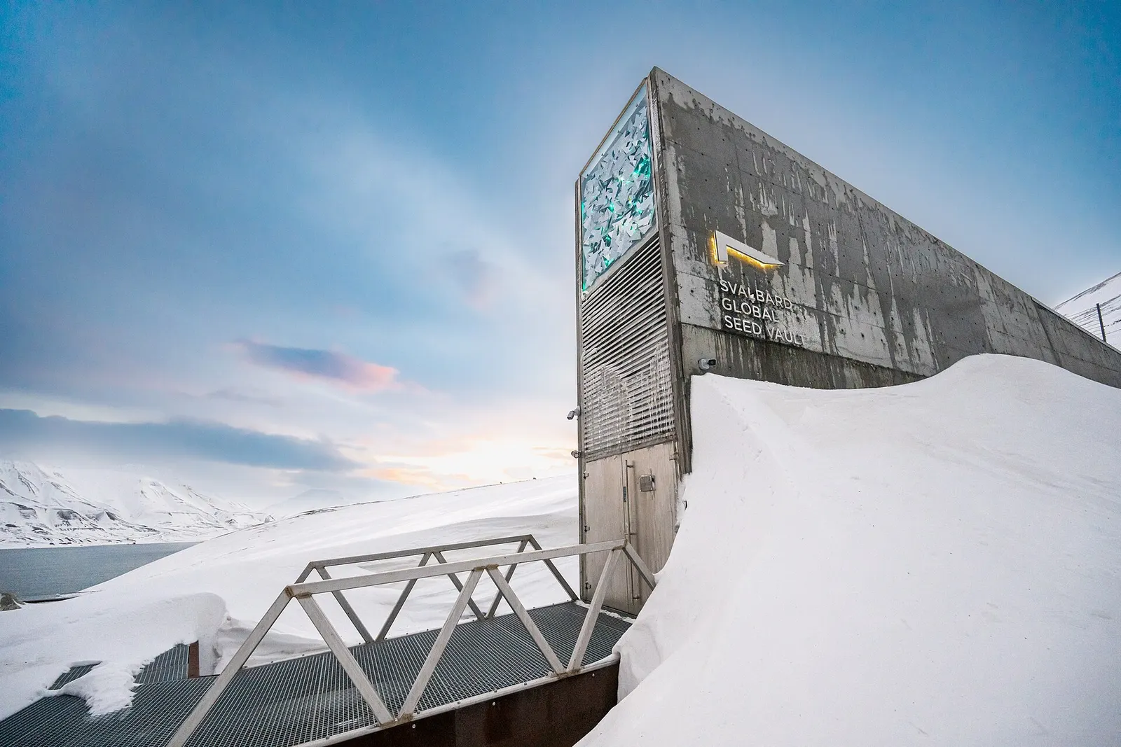 Michael Major for Crop Trust, exterior of Svalbard Global Seed Vault on 26 February 2025. Wikimedia Commons, CC BY-SA 2.0. This is the 1,920-pixel Wikimedia thumbnail rendition; no additional edits. https://commons.wikimedia.org/wiki/File:Svalbard_Global_Seed_Vault_February_2025.jpg