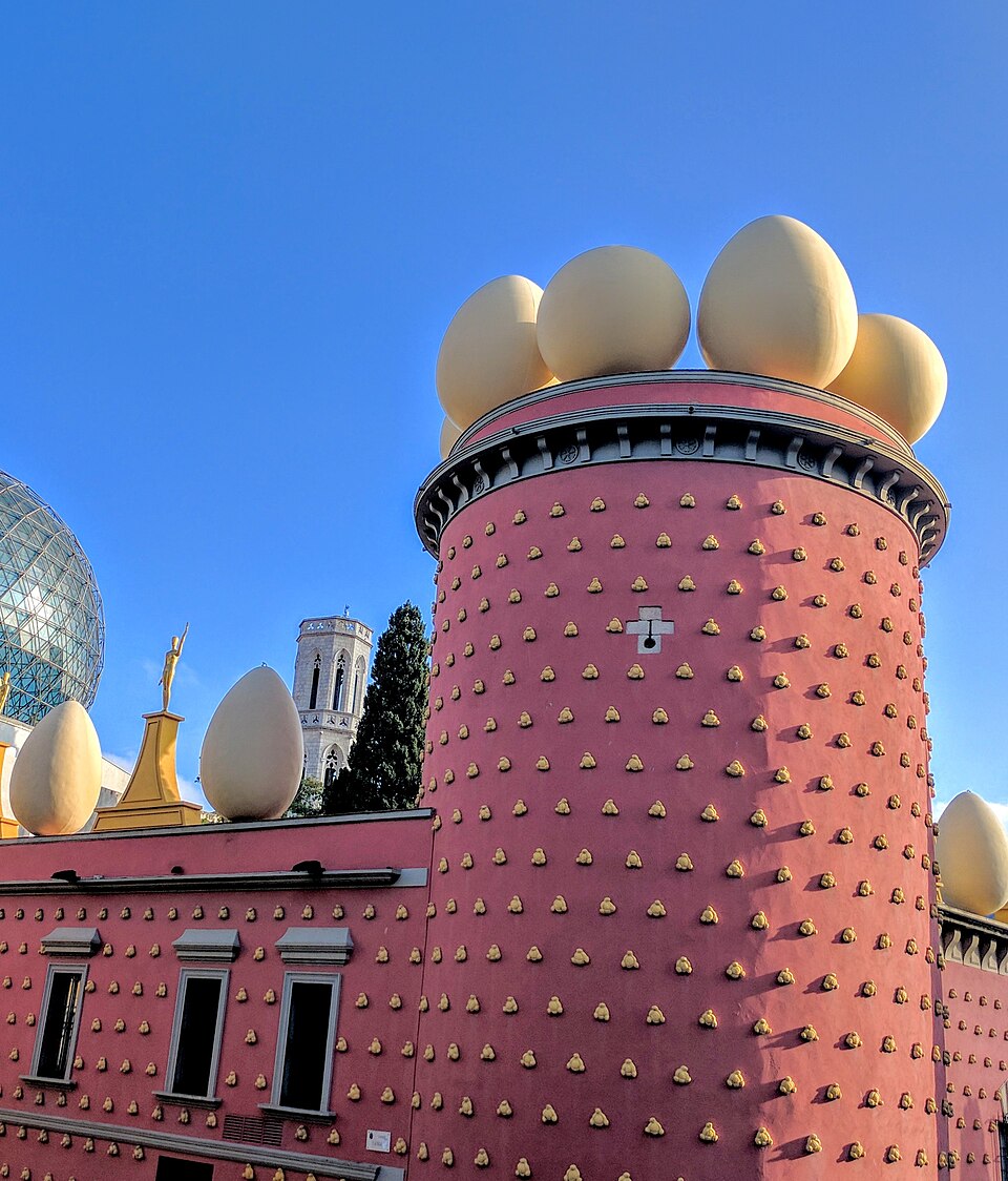 exterior view of Salvador Dalí’s Theatre-Museum in Figueres. Photographer: Marina Ibrishimova. Original page: https://commons.wikimedia.org/wiki/File:Salvador_Dali%27s_Museum_in_Figueres.jpg. CC BY-SA 4.0; credit Marina Ibrishimova; license https://creativecommons.org/licenses/by-sa/4.0/ . 960 px Wikimedia thumbnail, no crop. Checked and visually inspected 2026-10-28.