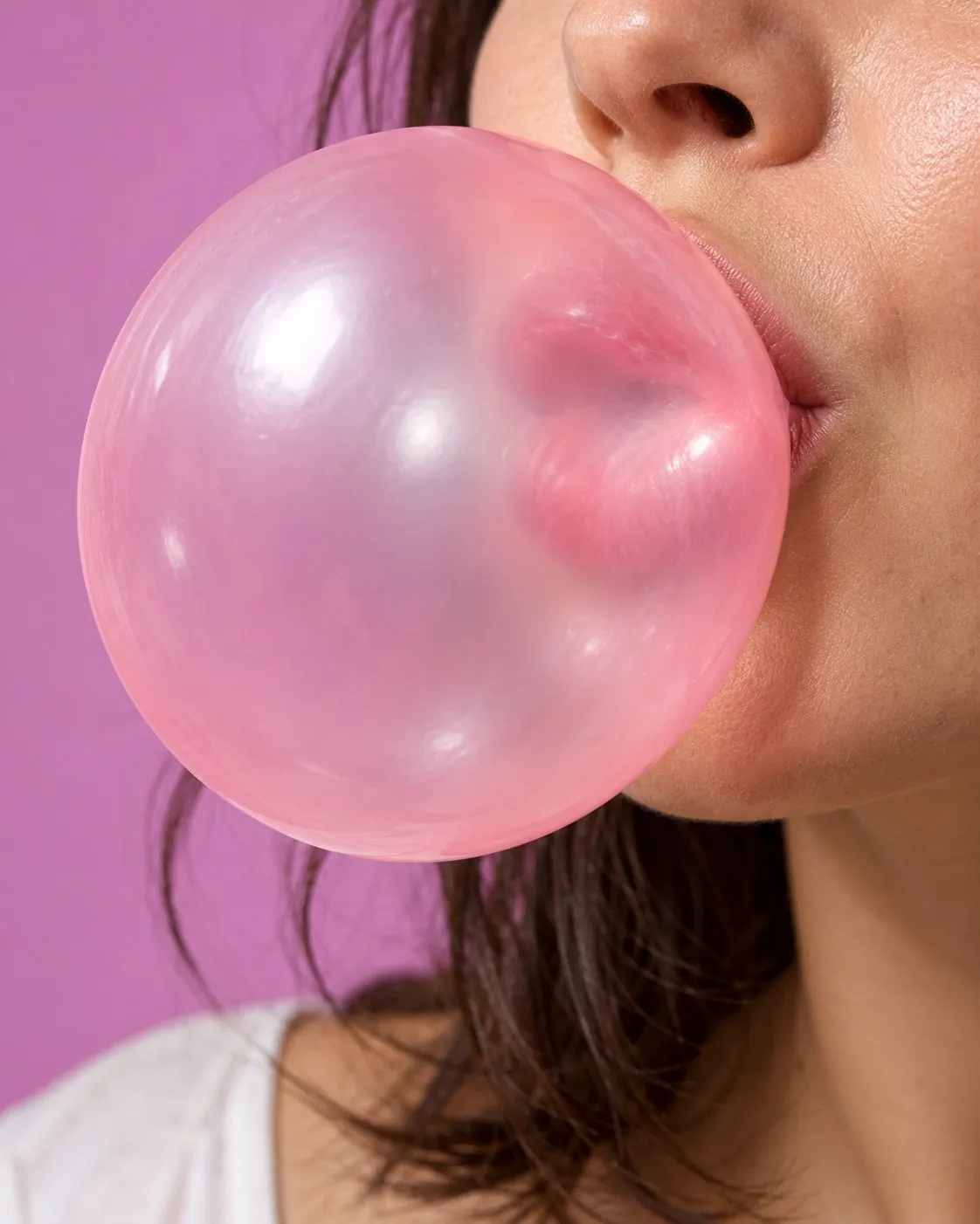 AI-generated cover of a fictional adult blowing a pink bubblegum bubble; not Chad Fell and no exact diameter implied. Prompt: “Photorealistic vertical 4:5 editorial cover of a large translucent pink bubblegum bubble being blown by a fictional adult, close framing on the bubble and lower face only, neutral colorful studio background, playful but realistic. Not Chad Fell or his 2004 record attempt; no exact diameter implied. No text, logos, labels or numbers.” Generated 20 October 2026.