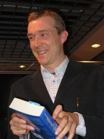 documentary photograph of British novelist David Mitchell at an event in Warsaw, 7 April 2006. Original page: https://commons.wikimedia.org/wiki/File:David_Mitchell_by_Kubik.JPG. Creator: Mariusz Kubik. License: GFDL, as stated on the Commons page; attribution to photographer Mariusz Kubik is required. No edits.