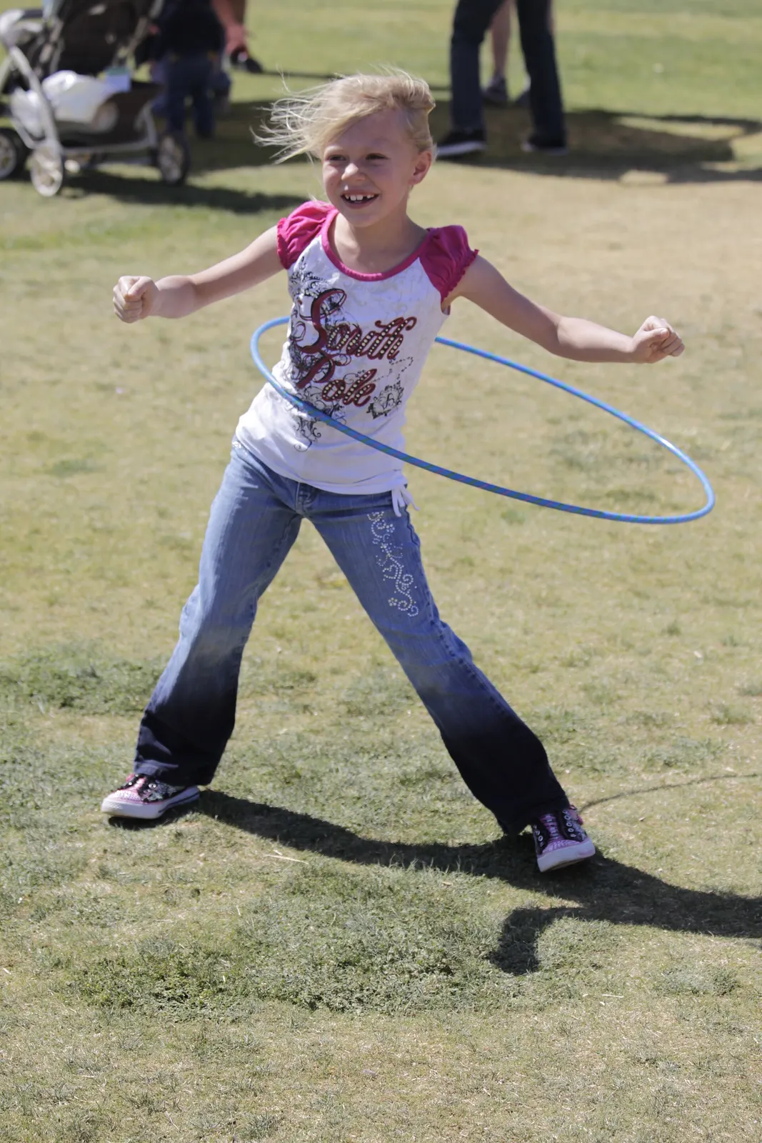 a child keeping a hula hoop around her waist at a U.S. Marine family event, 27 April 2011; photographer not identified on the file page; released by the U.S. Marine Corps under ID 110427-M-LV138-004 and public domain as a U.S. federal government work. Original page: https://commons.wikimedia.org/wiki/File:USMC-110427-M-LV138-004.jpg. Credit: U.S. Marine Corps (image ID 110427-M-LV138-004); no individual photographer is named on the source file page.